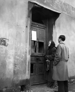 Passers-by stare at the eviction notices pinned up at Sophia Street, Butetown
