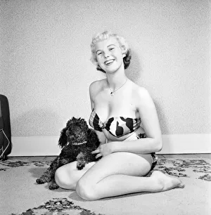 Pat Bolton seen here with her pet poodle dog. 1964 E298-004