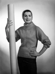 Knitwear Prints: Pat Goodard seen here modeling a beige jumper with hood December 1956 Rev