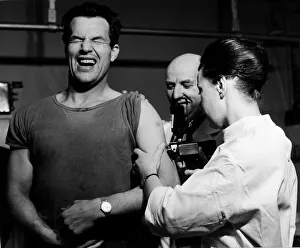 00097 Prints: A patient receiving his anti flu injection at a Cardiff City doctor