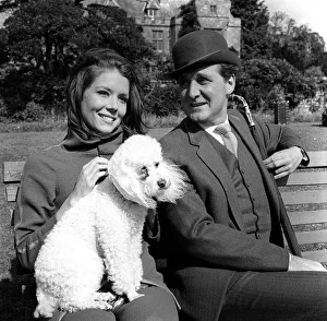 Patrick Macnee & Diana Rigg stars of The Avengers 1966 sitting on park bench with a