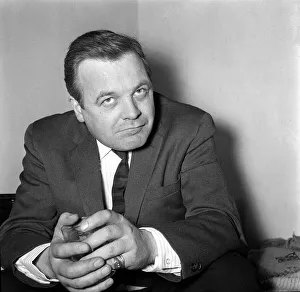 Patrick Wymark actor sitting holding glass April 1964