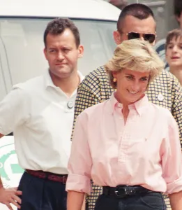 Paul Burrell (left, in the background in the white shirt and black trousers