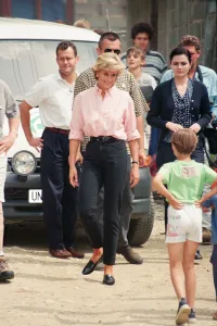 Paul Burrell (left, in the background in the white shirt and black trousers