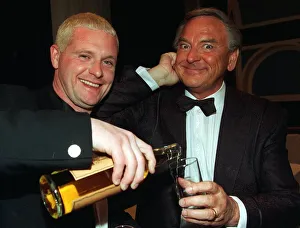 00006 Prints: Paul Gascoigne gives Bob Monkhouse pours from bottle glass whisky Ibrox last night