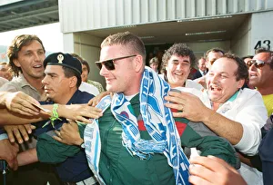Paul Gascoigne is mobbed by airport workers and Lazio fans on arrival in Rome