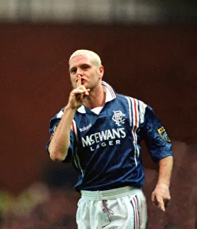 Paul Gascoigne of Rangers Football Club with his finger up to his mouth making a sign to