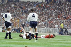 Injury Prints: Paul Gascoigne of Tottenham Hotspur Football Club lies on the ground waving to