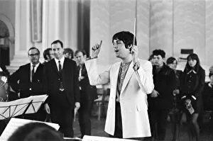 Paul McCartney of The Beatles, conducts the Black Dyke Mills Band, recording a record