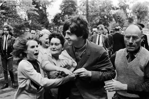 Beatlemania Prints: Paul McCartney of The Beatles is escorted past waiting fans as he arrives at ABC Studios