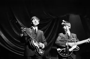 Paul McCartney and George Harrison of The Beatles performing on stage in Carlisle