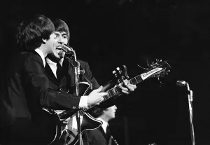 Paul McCartney and George Harrison in concert on the second night of their US tour