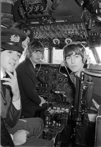Paul McCartney, George Harrison and Ringo Starr in the cockpit on the plane bound for