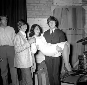 Paul McCartney holding Cherry Rowland as Ringo Starr watches at the Futurist theatre in