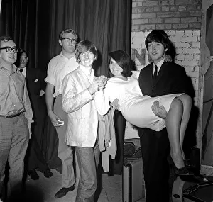 Paul McCartney holding Cherry Rowland as Ringo Starr watches at the Futurist theatre in