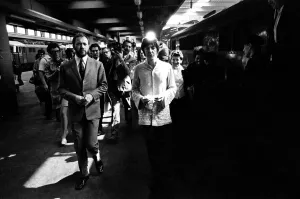 Paul McCartney walking along the platform to his awaiting train as The Beatles leave