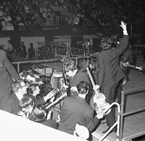 Paul McCartney waving and John Lennon leaving the stage at the NME poll winners all star