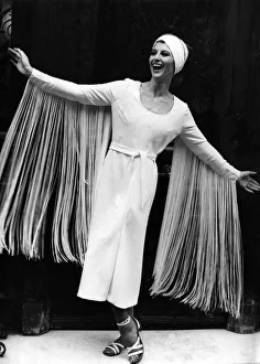 Paula Daly models a midi-length evening dress with eye-catching fringed sleeves