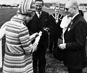 Katharine Prints: A pause for Katharine, Duchess of Kent, to admire the diamond brooch presented by Mr Eric