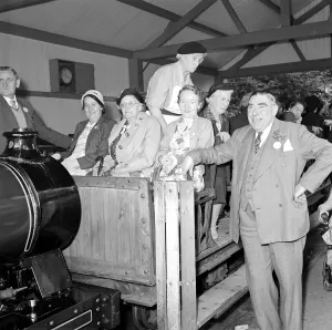 00177 Prints: Pensioners on a day trip to Trentham Park prepare for a tour of the park on a model