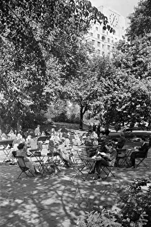 People enjoying afternoon tea in Victoria Gardens on the Embankment, London