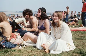 People sitting on grass at Isle of Wight Festival Hippies flower power