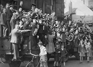 People on the streets celebrate the The VJ day victory parade in Newcastle at the end of