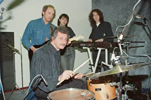 Pete Best, (in the black shirt holding his drum sticks) posing for the camera with his