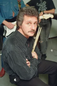 Pete Best, (in the black shirt holding his drum sticks) posing for the camera with his