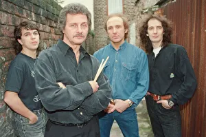 Pete Best, (in the black shirt holding his drum sticks) posing for the camera with his