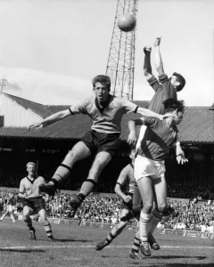 Peter Broadbent jumps high but cannot get his head to the ball as Bonetti the Chelsea