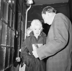 Peter Woods Daily Mirror Reporter showing singer Shani Wallis the story of her alleged