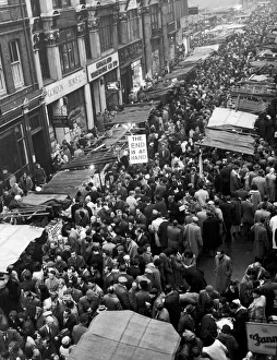 Market Stalls Prints: Petticoat Lane Market. Crowds milling around the market stalls in the run up to Christmas