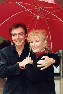 Petula Clark and David Cassidy under umbrella at photocall - July 1993