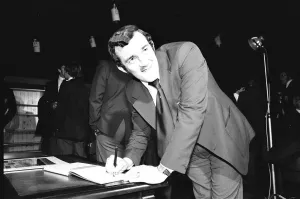 00414 Prints: Phil Bennett signing the visitors book at the International Sports Writers Club in Great