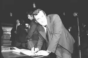 00414 Prints: Phil Bennett signing the visitors book at the International Sports Writers Club in Great