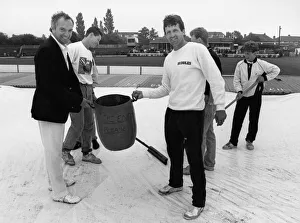 Bucket Prints: Phil Carrick Yorkshire skipper along with Sussex captain Paul Parker help with clearing