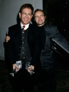 Phil Collins Singer and Elton John at award dinner at Park Lane Hotel