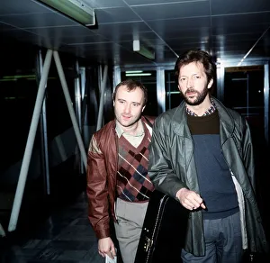 01139 Prints: Phil Collins Singer Songwriter Actor with Eric Clapton leaving London Airport for