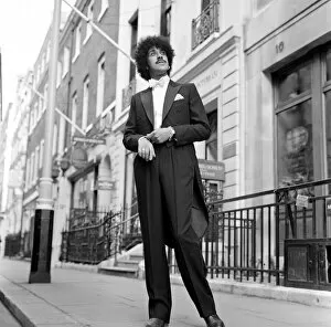 Images Dated 17th January 1983: Phil Lynott of Thin Lizzy modelling clothes from Saville Row, London