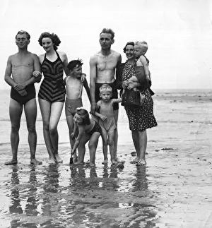 The photograph shows a family on the beach. September 1946 1940s