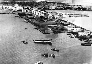 The photograph shows the shattered waterfront of the main supply port of Benghazi
