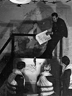 Reconnaissance Prints: Photographic Reconnaissance officers being briefed by an Intelligence Officer