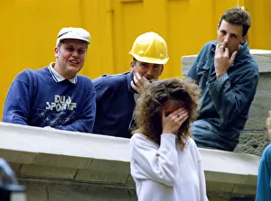 A picture showing the stereotypical behaviour of workmen wolf whistling pretty girls