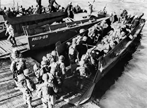 01219 Prints: This picture shows American troops going aboard a landing craft during the successful