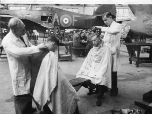 Hair Cut Prints: Picture shows young royal air force recruits getting their hair cut within an air craft