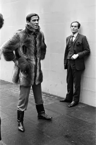 Male Prints: Pierre Cardin pictured with a model displaying one of his mens fashion designs