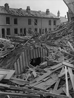Rubble Prints: A pile of rubble surrounds an Anderson shelter in the back garden of terrace housing off