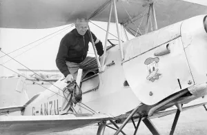 Pilot Prints: A pilot climbing aboard a de Havilland Tiger Moth at Bagington Airfield. Circa 1960