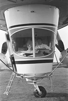 00394 Prints: The pilot at the controls of Goodyear airship Europa seen here moored outside the giant